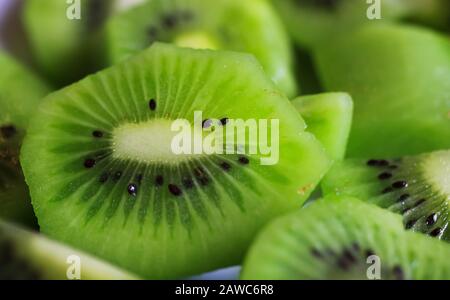Macro plein format gros plan gros plan de fruits kiwi frais et brillants en tranches Banque D'Images