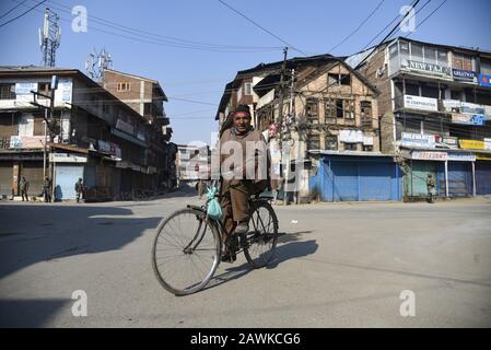 Un homme fait du vélo dans une rue fermée pendant l'arrêt de Srinagar.des restrictions au mouvement des véhicules ont été imposées à des protecteurs dans certaines parties de Srinagar en tant que Front de libération du Jammu-Cachemire (JKLF), Un groupe séparatiste de la vallée a appelé à une grève pour observer les anniversaires de mort d'Afzal Guru et du fondateur de JKLF Maqbool Bhat. Afzal Guru était un Kashmiri qui a été reconnu coupable et condamné à mort pour son rôle dans l'attaque de 2001 contre le Parlement indien. L'appel à une grève de JKLF est le premier de tout groupe séparatiste depuis le 5 août 2019, lorsque le gouvernement central dirigé par le BJP a révoqué l'article 3 Banque D'Images