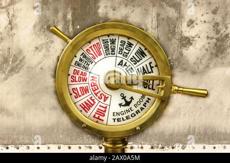 Ancien télégraphe de salle de moteur devant un fond de bateau en acier érodé Banque D'Images
