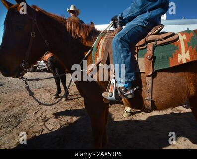 Un membre monté d'un groupe appelé Cowboys for Trump est assis sur son cheval avec ses bottes dans les étriers lors d'un rassemblement pro-Trump à New Mexicos USA. Banque D'Images