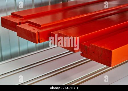 Éléments de meubles peints dans la cabine de pulvérisation. Émail rouge. Fabrication de meubles... Processus de fabrication de meubles en bois Banque D'Images