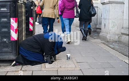 Femme mendiant à North Street Brighton tout en apparaissant pour prier East Sussex UK Photographie prise par Simon Dack Banque D'Images