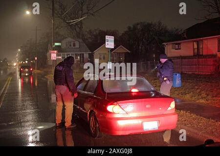 Les policiers de Detroit s'approchoch en véhicule lors d'un arrêt de circulation pendant une nuit de pluie à Detroit, Michigan, États-Unis Banque D'Images