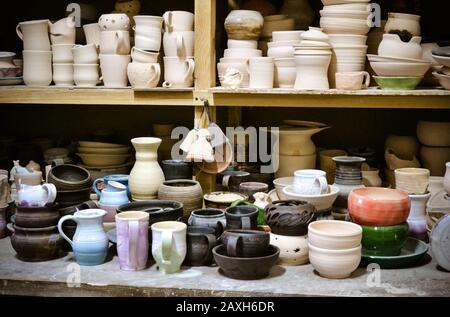 de nombreuses poteries différentes se tenant sur les étagères dans un atelier de poterie. Faible luminosité Banque D'Images