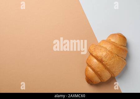 Croissant fraîchement cuit sur fond à deux tons, vue sur le dessus Banque D'Images