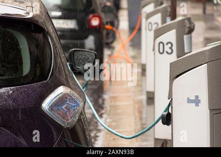 Station de charge de véhicules électriques dans la rue à Paris avec certaines voitures connectées Banque D'Images