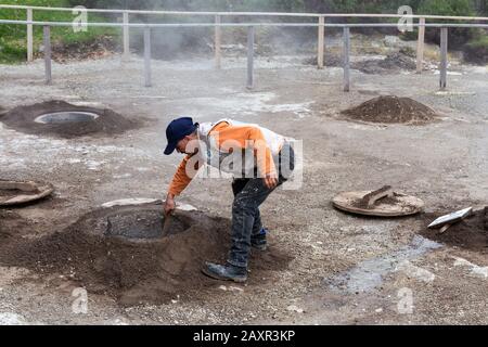 Furnas, Açores - février 2020: Trois hommes enlevant 'Cozido das Furnas', des aliments cuits aux ouvertures volcaniques de l'île de Sao Miguel, aux Açores, au Portugal Banque D'Images