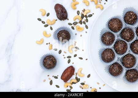 Graines de dattes et boulettes d'énergie à base de noix végan maison. Fait avec des dattes de médules, noix de cajou, chanvre, graines de tournesol et de citrouille et noix de coco déshydratée Banque D'Images