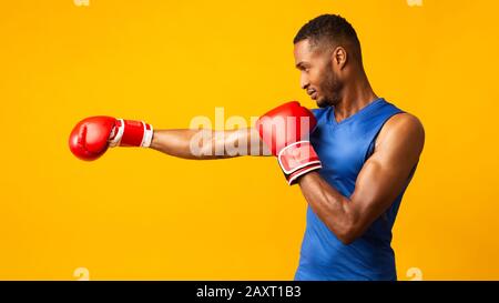 Portrait d'un homme noir confiant portant des gants rouges Banque D'Images