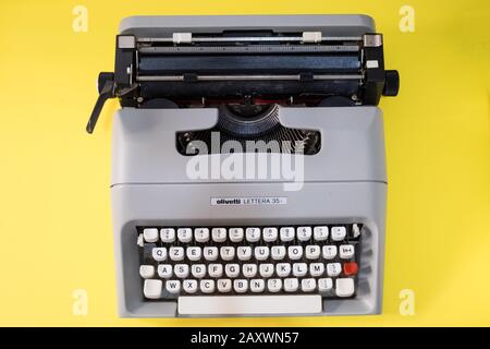 Machine à écrire mécanique prise de dessus sur fond jaune, marque Olivetti, modèle Lettera35. Banque D'Images
