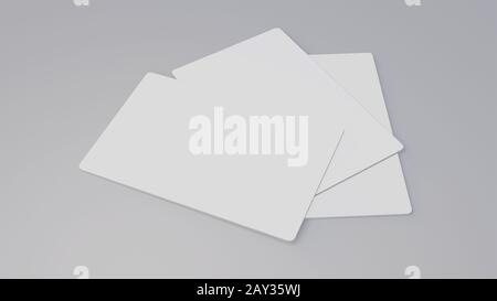 Carte cadeau blanche carte de crédit maquette empilable sur fond de table gris. Arrière-plan de l'objet pour l'impression du modèle de présentation de marque commerciale 3.370 x 2.12 Banque D'Images