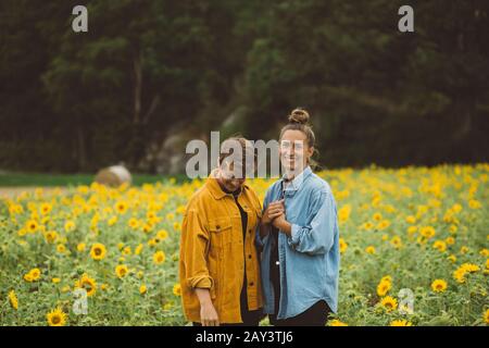 Couple sur champ de tournesol fleuri Banque D'Images