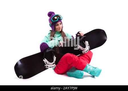 Jolie jeune femme en costume de ski violet de l'emplacement en tailleur Banque D'Images