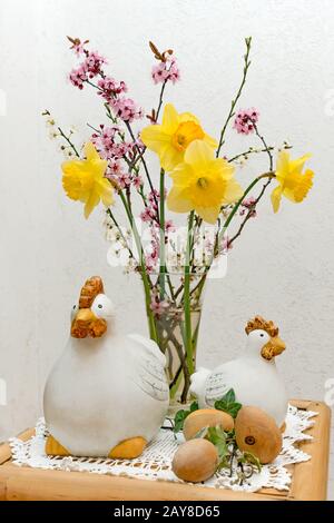 Bouquet avec décoration de Pâques composé de figurine de poulet et d'œufs en bois sur une table Banque D'Images