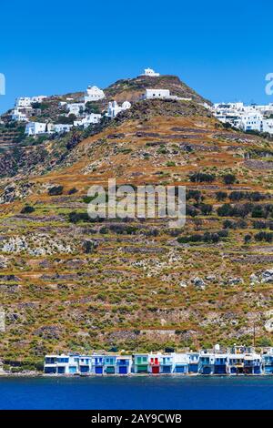 Plaka Klima et villages sur la côte de l'île de Milos vu depuis le ferry. Banque D'Images