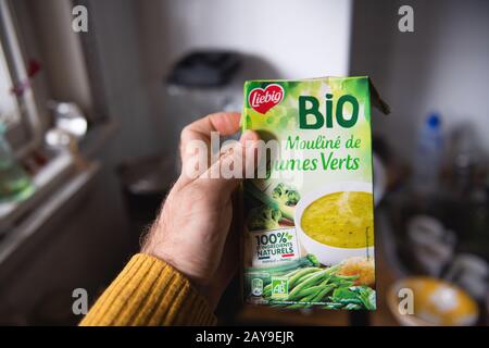 Paris, France - 28 janvier 2020: Main de l'homme tenant contre la cuisine arrière-plan paquet de Bio soupe fabriqué acheter Leibig Banque D'Images