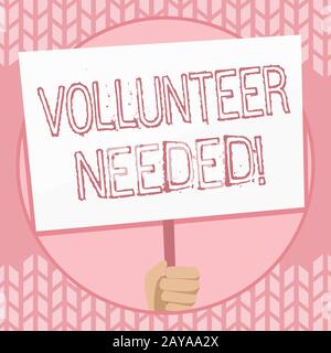 Note d'écriture montrant le volontaire nécessaire. Photo d'affaires présentant besoin de travail pour l'organisation sans être payé main Holding Whit Banque D'Images