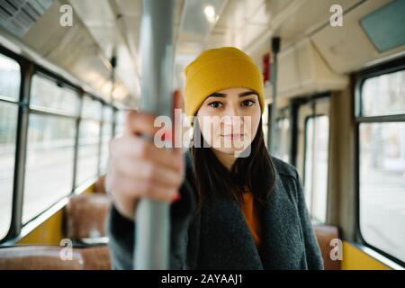 Jeune femme debout dans un wagon d'un tramway de conduite. Transports, voyages et de style de concept. Banque D'Images