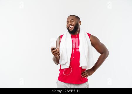 Handsome African American man listening music sur son appareil mobile après le sport l'exercice physique. Banque D'Images