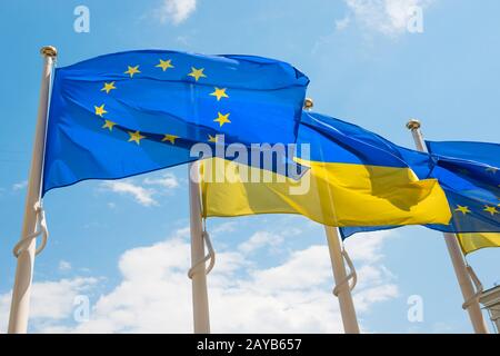 Drapeaux avec Union européenne et Ukraine sur fond bleu ciel Banque D'Images