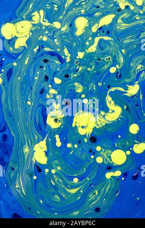 Fond de peinture acrylique mélangé dans des couleurs jaune-bleu. Banque D'Images