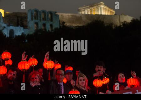 (200216) -- BEIJING, 16 février 2020 (Xinhua) -- les Grecs et les Chinois vivant en Grèce détiennent des lanternes rouges au pied de la colline de l'Acropole à Athènes, Grèce, 14 février 2020. Sous les auspices de la ville d'Athènes, la Chambre de coopération économique entre la Grèce et la Chine, ainsi que des associations d'entreprises de la communauté chinoise à Athènes et d'autres groupes représentant les citoyens d'Athènes, ont organisé l'événement pour exprimer leur solidarité avec le peuple chinois qui lutte contre la nouvelle flambée de coronavirus et la stigmatisation. (Xinhua/Marios Lolos) Banque D'Images