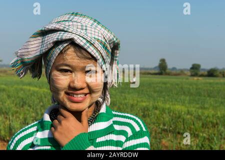 Une adolescente ferme travaille dans un champ planté d'oignons le long de la route de Bagan à Mandalay au Myanmar. Banque D'Images