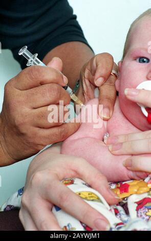 Bébé ayant sa première vaccination DTP/polio/Hib Banque D'Images