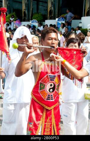 Thaïlande: Un préposé essuie la bouche d'un 'sa Song' (dévot d'entrée), Festival végétarien de Phuket. Le Festival végétarien est un festival religieux qui se tient chaque année sur l'île de Phuket dans le sud de la Thaïlande. Il attire des foules de spectateurs en raison de nombreux rituels religieux inhabituels qui sont exécutés. Beaucoup de dévotés religieux se slaleront avec des épées, perce leurs joues avec des objets pointus et commettent d'autres actes douloureux. Banque D'Images