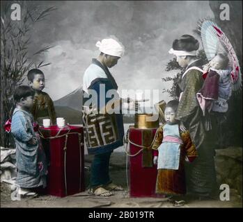 Japon: Un vendeur itinérant de boissons non alcoolisées 'Amazake'. Photo de T. Enami (1859-1929), c. 1895. T. Enami (Enami Nobukuni) était le nom commercial d'un célèbre photographe de l'époque Meiji. Le T. de son nom commercial est censé avoir représenté Toshi, bien qu'il ne l'ait jamais écrit sur aucun document personnel ou d'affaires. Né à Edo (aujourd'hui Tokyo) pendant l'ère Bakumatsu, Enami a d'abord été étudiant, puis assistant du célèbre photographe et collectionniste, Ogawa Kazumasa. Enami a déménagé à Yokohama, et a ouvert un studio sur Benten-dōri (rue Benten) en 1892. Banque D'Images