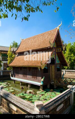 Wat Puttha En (วัดพุทธเอ้น) est un temple typique du nord de la Thaïlande, établi en 1868. Il est surtout remarquable pour sa petite maison en bois, le bot nam (โบสถ์น้ำ) ou la salle d'ordination, construite au sommet des piliers au centre d'un étang carré de lotus. Ces "chapelles d'eau" sont rares en Thaïlande. Le viharn récemment rénové est attrayant mais sans remarquable, mais derrière, sur des pieux en bois rouge étiolés, se trouve un ho trai de style nord (bibliothèque d'écriture), décoré de motifs rouges et or lai kram. Niché dans une vallée étroite, Mae Chaem (แม่แจ่ม) doit se classer comme l'un des coins les moins accessibles de Chiang Mai. Banque D'Images