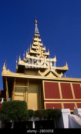 Le château du fort Mandalay, à près de 3 km (3 miles) de murs, abrite le palais du roi Mindon. Les murs s'élèvent à 8 m (26 pi). Le palais a été construit entre 1857 et 1859 dans le cadre de la fondation par le roi Mindon de la nouvelle capitale royale de Mandalay. Le plan du palais de Mandalay suit en grande partie la conception traditionnelle du palais birman, à l'intérieur d'un fort fortifié entouré d'une lune. Le palais lui-même est au centre de la citadelle et fait face à l'est. Tous les bâtiments du palais sont d'une histoire en hauteur. Le nombre de spires au-dessus d'un bâtiment a indiqué l'importance de la zone ci-dessous. Mandalay, une ville tentaculaire de plus de th Banque D'Images