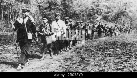 Sur une photo en scène, une troupe de guérilleros khmers rouges se déroule dans la jungle de l'ouest du Cambodge. Pol Pot progresse dans le plomb, suivi de son garde du corps personnel, puis frère no 2, Nuon Chea. Ieng Sary (en noir) est 11ème de gauche. Le message aux Vietnamiens et au monde extérieur: "Nous sommes encore ici et une force viable". Banque D'Images