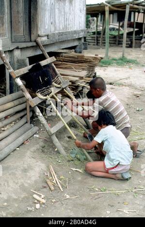 INDONÉSIE, SUMATRA, LINGGA, KARO BATAK VILLAGE, BOYS LOCAUX FAISANT DES BALAIS Banque D'Images