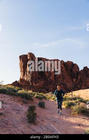Femme asiatique senior randonnée dans le paysage du désert Banque D'Images