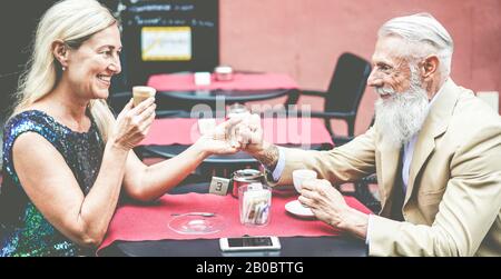 Heureux couple senior boire du café assis dans un bar extérieur - personnes d'âge mûr s'amuser à une date - Joyeuse sénior actif style de vie concept - Focus sur Banque D'Images