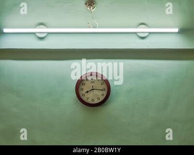 20 février 2020 horloge Poussiéreuse sur mur vert d'aqua dans la maison à Lok Gram Kalyan.Maharashtra Inde Banque D'Images