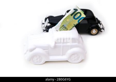 La caisse en céramique en forme de voiture avec un billet à l'intérieur avec une voiture modèle derrière. Il peut être le symbole des coûts des réparations, des investissements et des économies de la voiture Banque D'Images