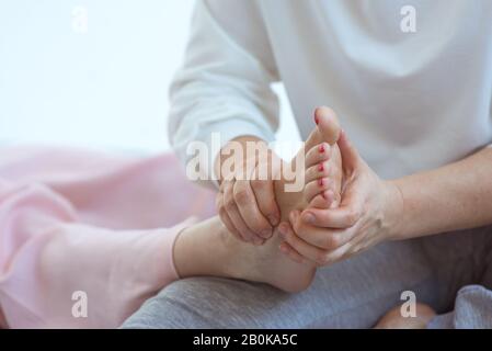 Massage des pieds thaïlandais à la main. Médecine alternative et massage thaïlandais concept Banque D'Images