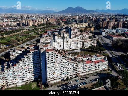 Vue sur les voiles dans le quartier de Scampia à la périphérie de Naples. La banlieue napolitaine du nord de Scampia est connue pour ses guerres de drogue, les batailles de clan entre les factions rivales mafias (Camorra) et a été présentée dans le film Gomorrah. En arrière-plan le volcan Vésuve. 21/02/2020, Naples, Italie Banque D'Images