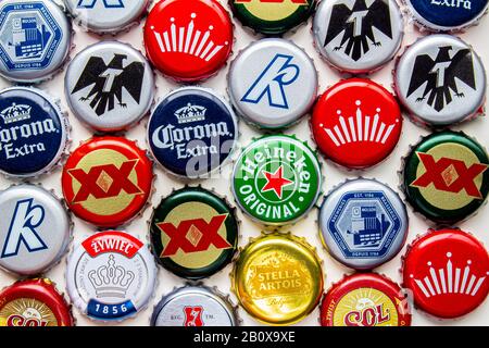 Calgary, Alberta, Canada. 21 Févr. 2020. Plusieurs capsules de bouteilles de bière sur fond blanc. Corona, Stella, Budweiser, Dosequis, Molson, Sol, Tecate, Kokan Banque D'Images