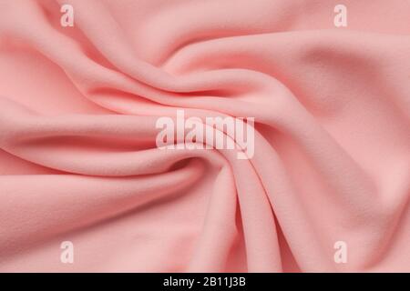 Texture d'arrière-plan en polaire rose, tissu isolant doux et tissé en polyester, motif ondulé abstrait, vue du dessus Banque D'Images