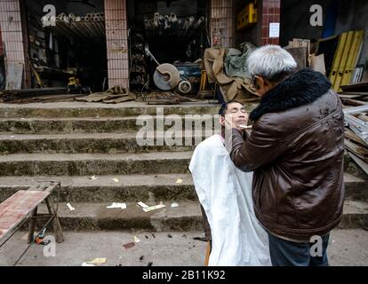 Rue barber dans un village de la province du Sichuan, Chine Banque D'Images