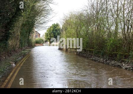 Eaux d'inondation brumeuses qui coupent la route et le logement dans la ville d'Upton sur Severn Banque D'Images