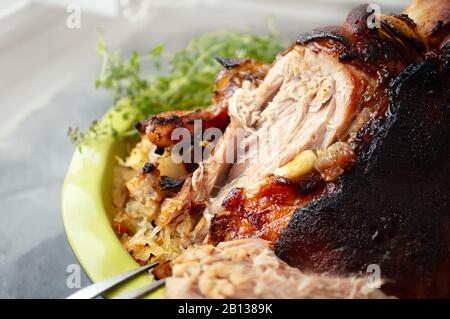 Un morceau de jarret de porc frit avec un plat latéral de sauerkraut. Plat national de viande tchèque et allemande. Gros plan. Banque D'Images