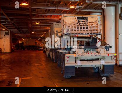 200222-N-FO574-1001 PORT DE BEAUMONT (FÉVR 22, 2020) les marins Sous Contrat affectés au commandement du Seallift militaire Bob Hope-classe grand, à vitesse moyenne, le navire rouleur USNS Benavidez (T-AKR 306) et Les Soldats de l'armée américaine guident la famille des Véhicules tactiques moyens dans une soute de fret. Benavidez est en cours à l'appui d'Agile Defender 2020. (ÉTATS-UNIS Photo marine par Mass Communication Specialist 3ème classe Jordan R. Bair/libéré) Banque D'Images