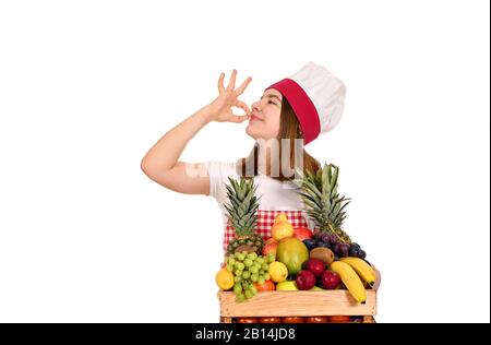 les femmes cuisinent avec des fruits et un bon signe de main Banque D'Images