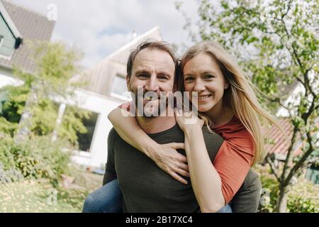 Heureux couple debout dans leur jardin Banque D'Images