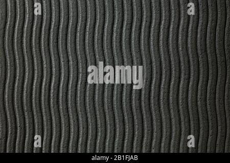 Gros plan de la surface de la texture de paroi ondulée grise pour le fond d'écran ou les fonds d'écran des appareils. Conception abstraite, matériaux habituels et naturels. Des œuvres d'art grungie détaillées. CopySpace, publicité. Style vintage. Banque D'Images