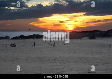 Les gens qui volent des cerfs-volants et regardent le soleil se coucher sur Albemarle Sound au parc national de JockeyÕs Ridge, le plus haut Banque D'Images